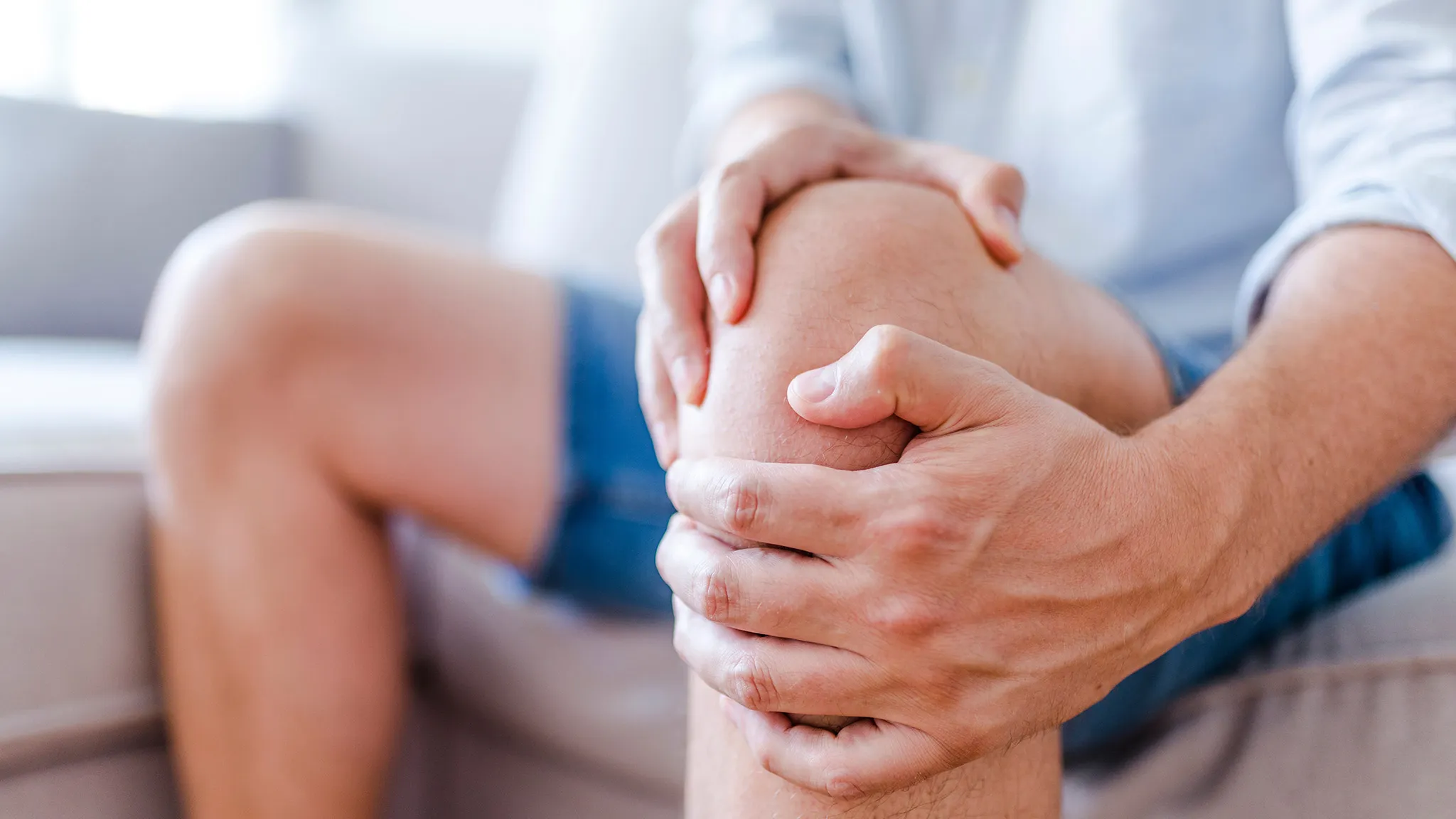 Hände umschlingen ein Knie